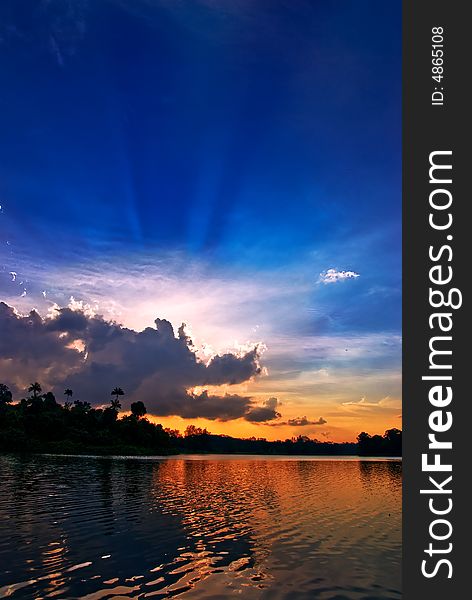 Dragon-shaped clouds poised to swallow the sun whole as it sets at Macritchie reservoir, Singapore. Dragon-shaped clouds poised to swallow the sun whole as it sets at Macritchie reservoir, Singapore.