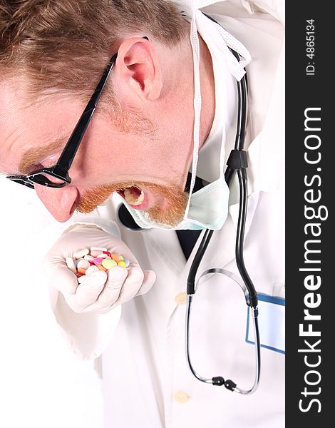 Doctor taking hand full of tablets on white background