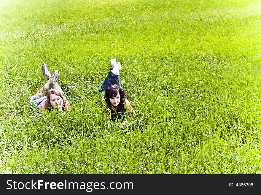 Two young friends enjoying on the grass. Two young friends enjoying on the grass