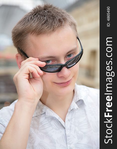 Young man in sunglasses indoor