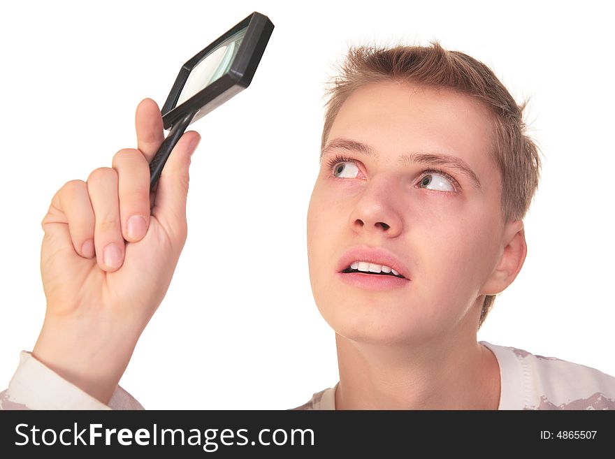 Young man looks through magnifier