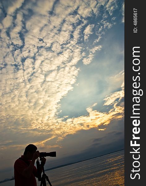 Sunrise with cloud formation with photographer sihouletted in the foreground. Sunrise with cloud formation with photographer sihouletted in the foreground.