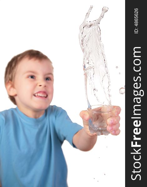 Boy spills water from glass on white