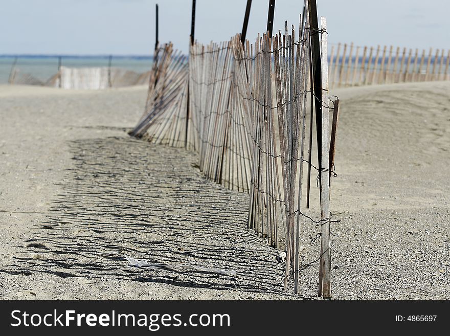 A beach fence along a Canadian lake.