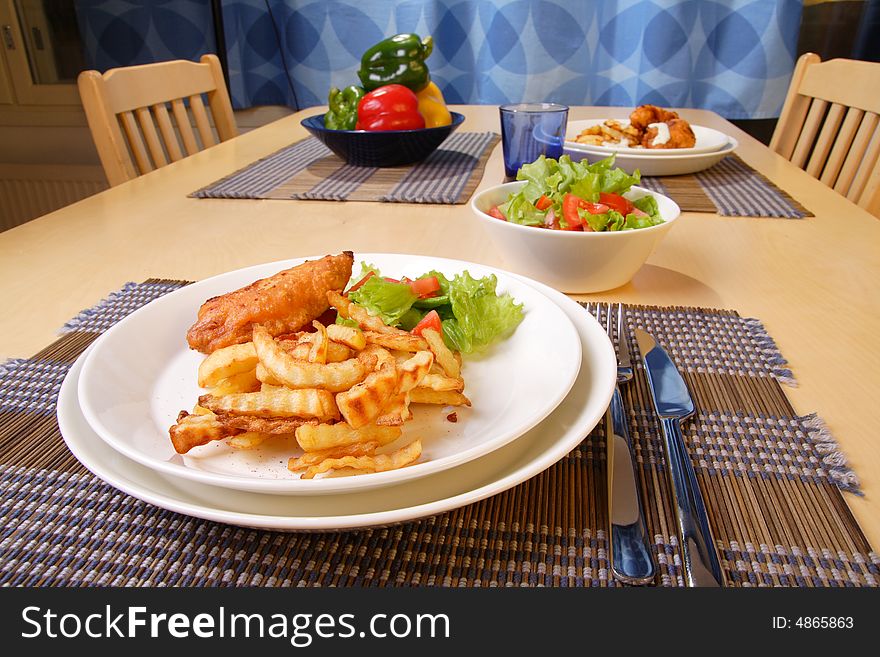 French fries and chicken legs on the plate with garlic sauce