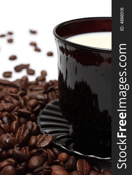 Coffee beans and milk in cup close-up. Coffee beans and milk in cup close-up