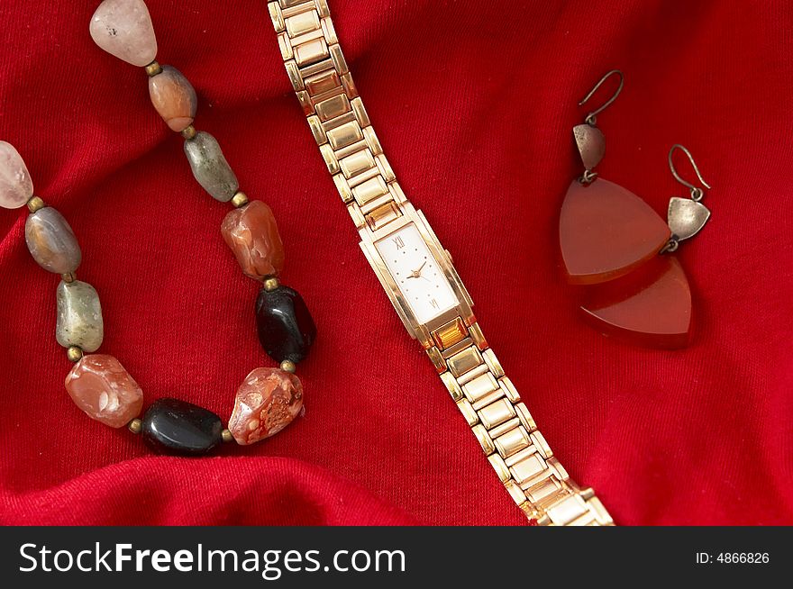 Golden watch, agate beads and earings. Golden watch, agate beads and earings