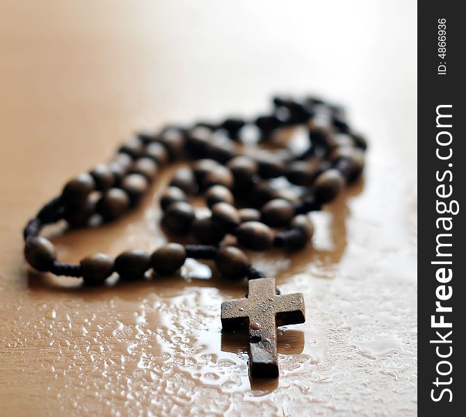 A rosary on wet background