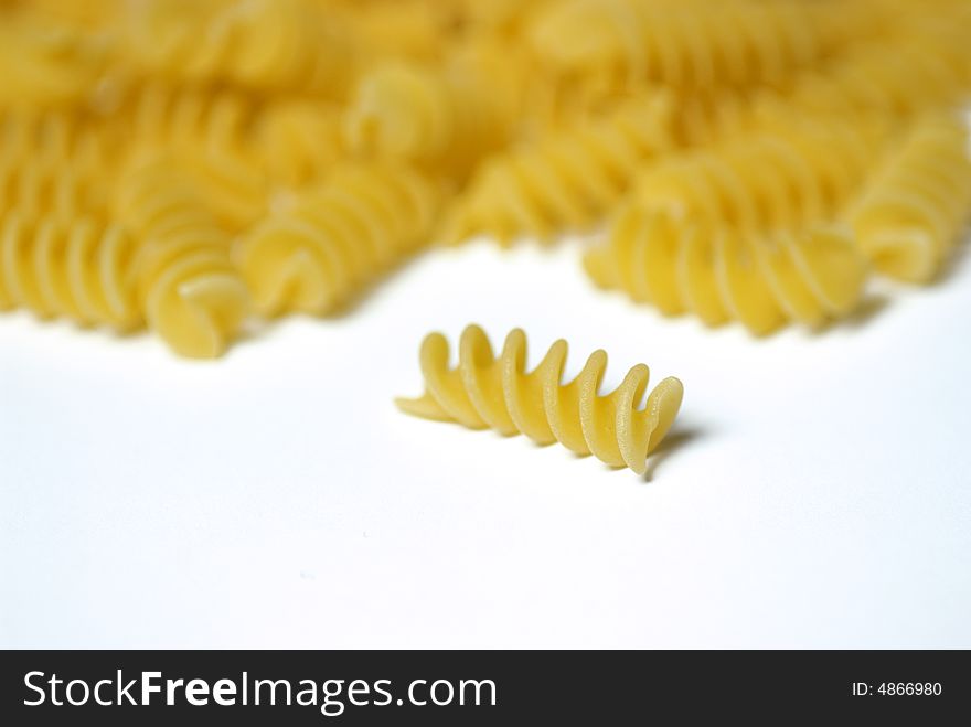 Italian fusilli pasta falling out of a glass jar