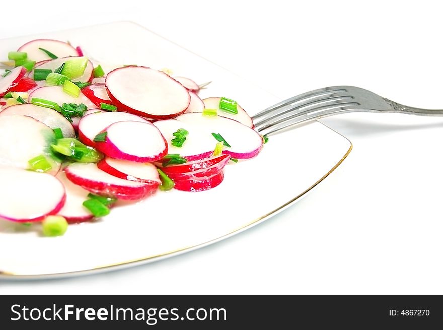 Salad from radish, green onion on plate with fork