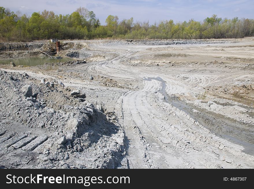 Huge opencast mine for digging the gault with the lake in the middle