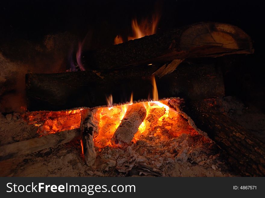 Logs burning in a fireplace - Liguria, Italy