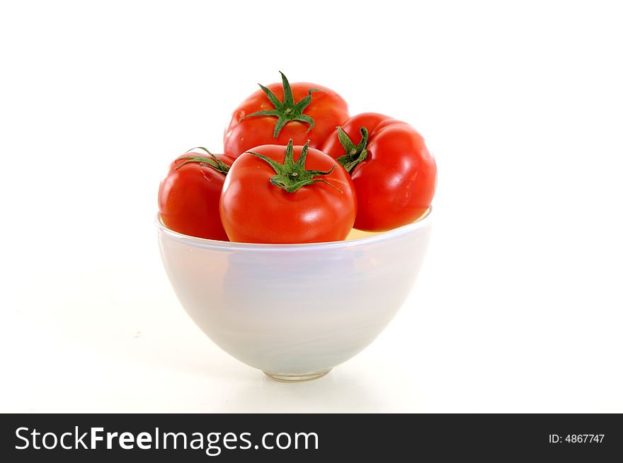 Tomatoes in the bowl on white background