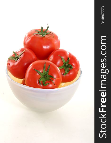 Tomatoes in the bowl on white background