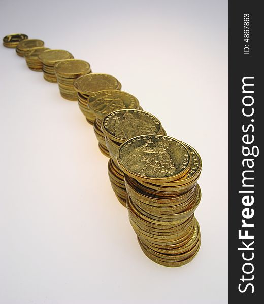 It is  lot of coins on  light background,  close up