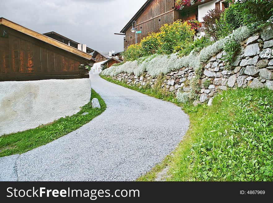 Moving way by a mountain village in the alps. Moving way by a mountain village in the alps.