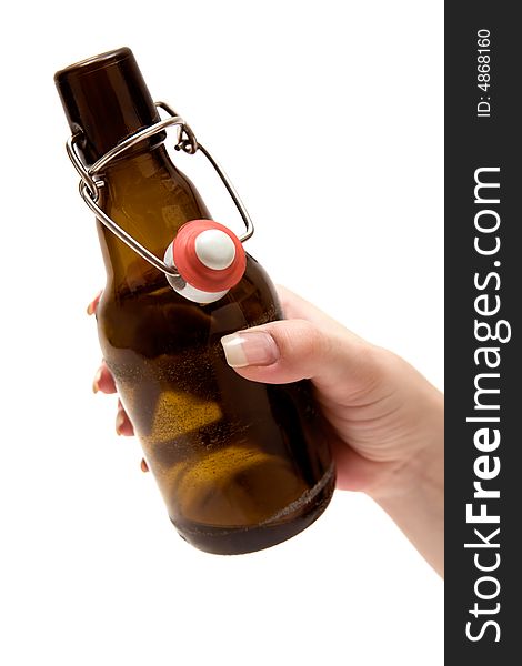 Female hand holding an opened beer bottle. Isolated on a white background. Female hand holding an opened beer bottle. Isolated on a white background.