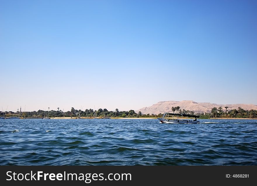 View on the coastline of the egyptian nile with sailing boat. View on the coastline of the egyptian nile with sailing boat