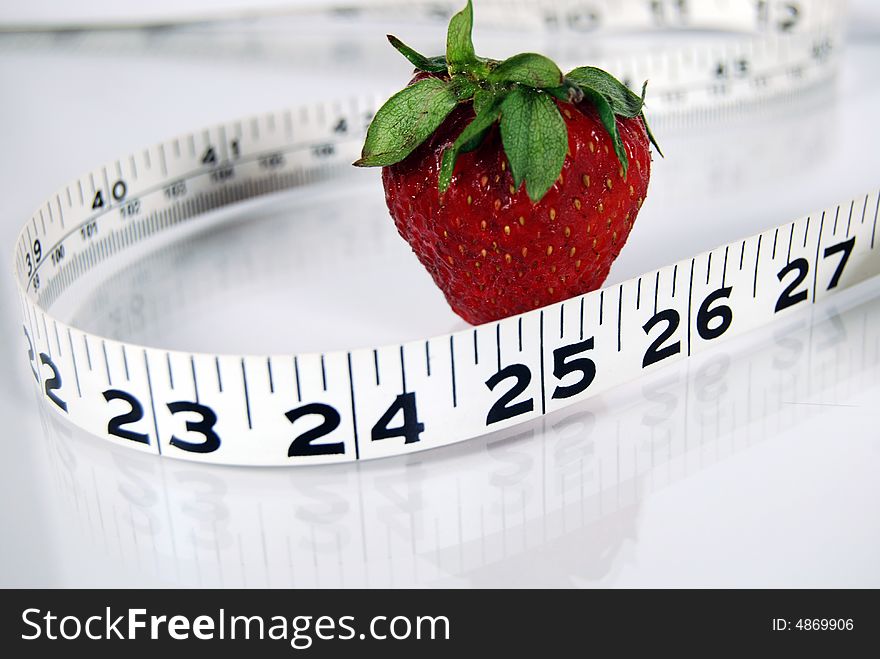 Single strawberry with measuring tape. Single strawberry with measuring tape.