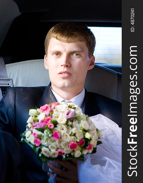 Groom with flower bouquet in the car. Groom with flower bouquet in the car