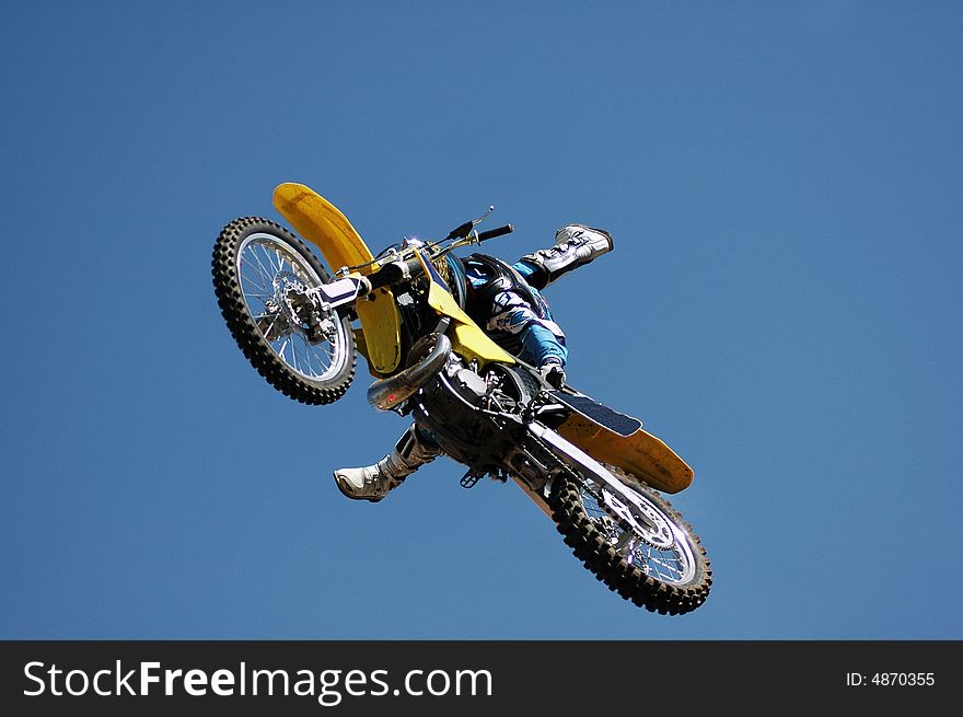 A stunt biker high up in the air. Photographed in South Africa. A stunt biker high up in the air. Photographed in South Africa.