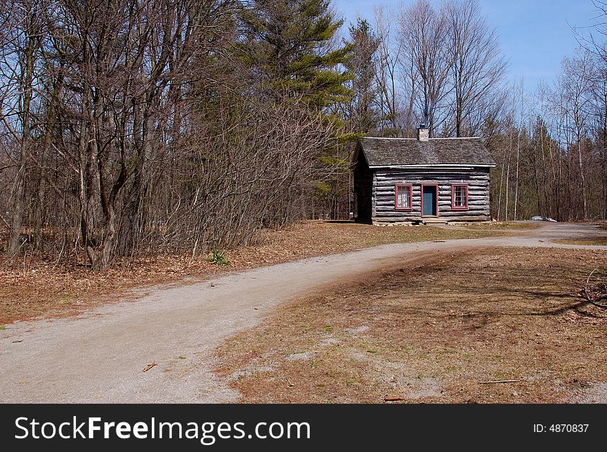 An image of a pathway leading to a cabin under a sunny day. An image of a pathway leading to a cabin under a sunny day.