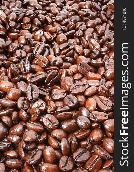 Dark and shiny French Roasted coffee beans background. View more of my coffee image collection.