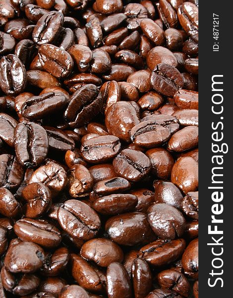 Dark and shiny French Roasted coffee beans background. View more of my coffee image collection.