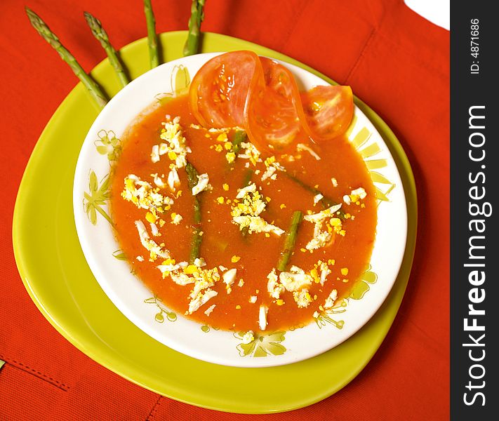 Creamy tomato soup with cheese and asparagus