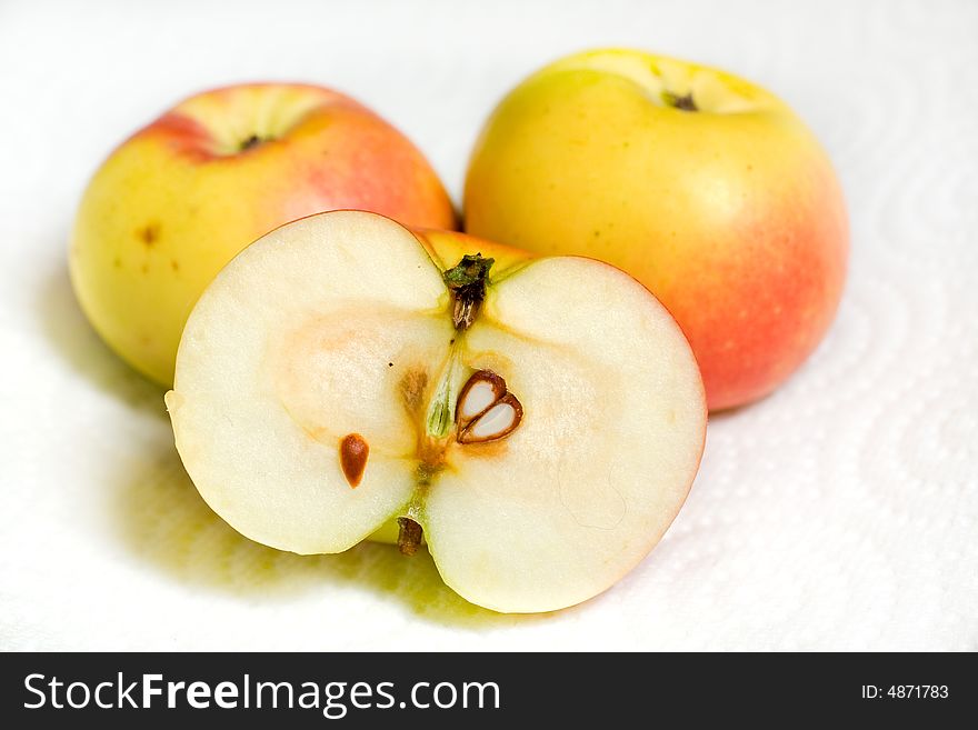 Closeup of three lady apples, one sliced in half