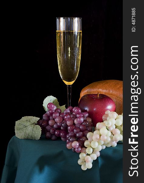 Champagne Glass with surrounding bread and fruit. Champagne Glass with surrounding bread and fruit