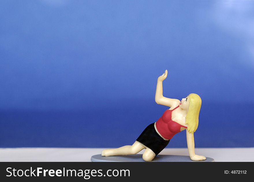 Figurine of a scared woman, hand up