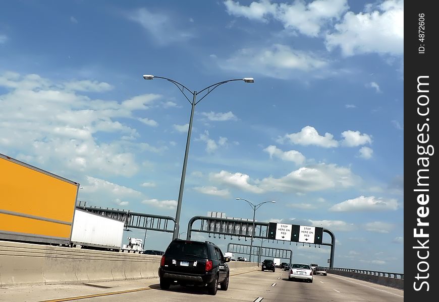Vehicles traveling over a bridge on a major highway. copy space included. Vehicles traveling over a bridge on a major highway. copy space included