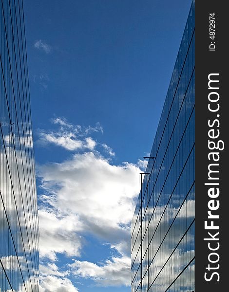 Glass buildings with sky reflections and cloudscape