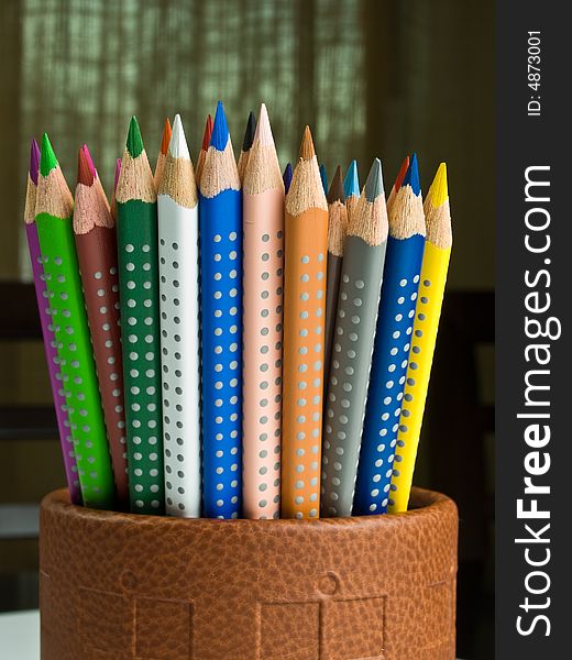Some pencils in a leather pencil holder. Some pencils in a leather pencil holder.
