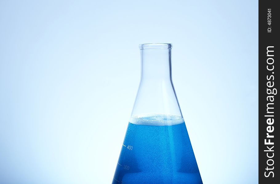 Erlenmeyer flask filled with blue liquid blue tint with copyspace