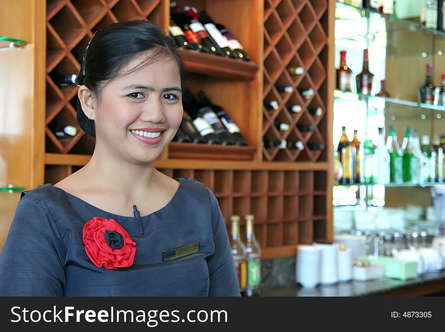 Photograph of bartender smiling at work