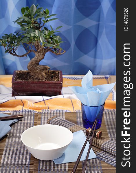 Asian style decorated table, soup bowl in the foreground