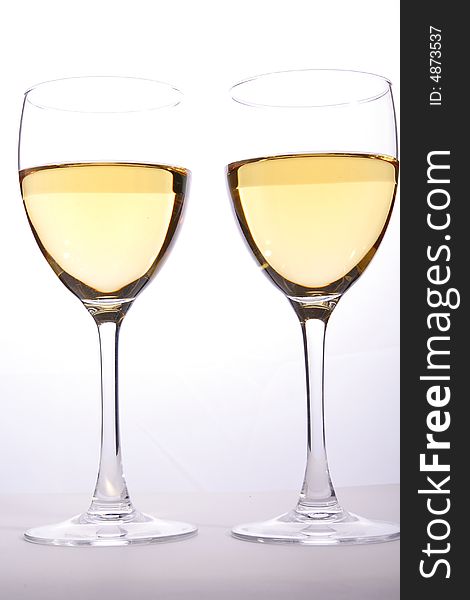 Wine glasses with white wine in studio light