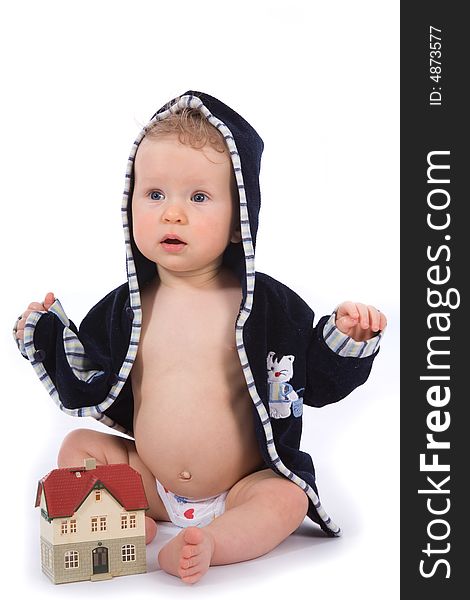 Baby with house model on white