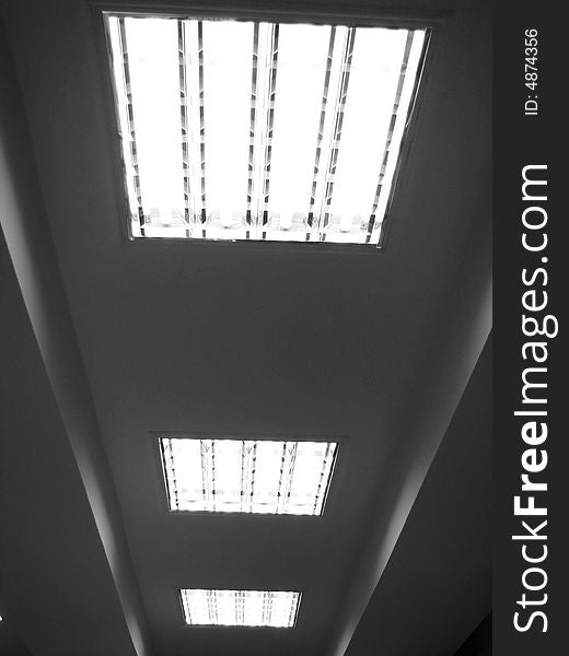 Row of fluorescent white lamps on ceiling. Row of fluorescent white lamps on ceiling