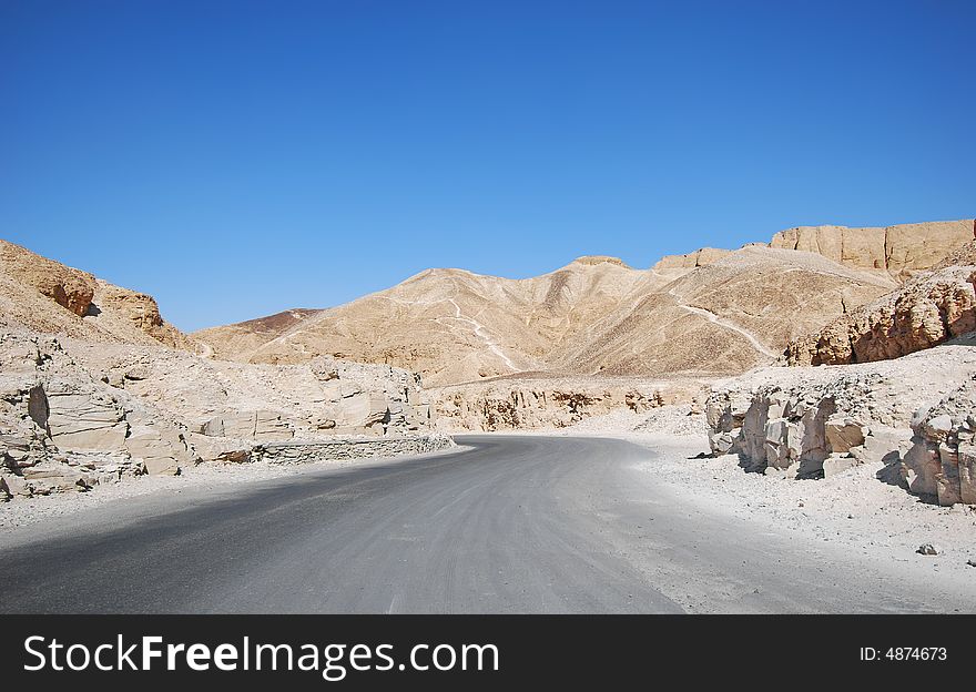 Road through the desert and sandy hills - valley of the kings in Luxor (ancient Thebes), Egypt. Road through the desert and sandy hills - valley of the kings in Luxor (ancient Thebes), Egypt