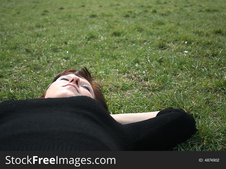Women rest on the grass. Women rest on the grass