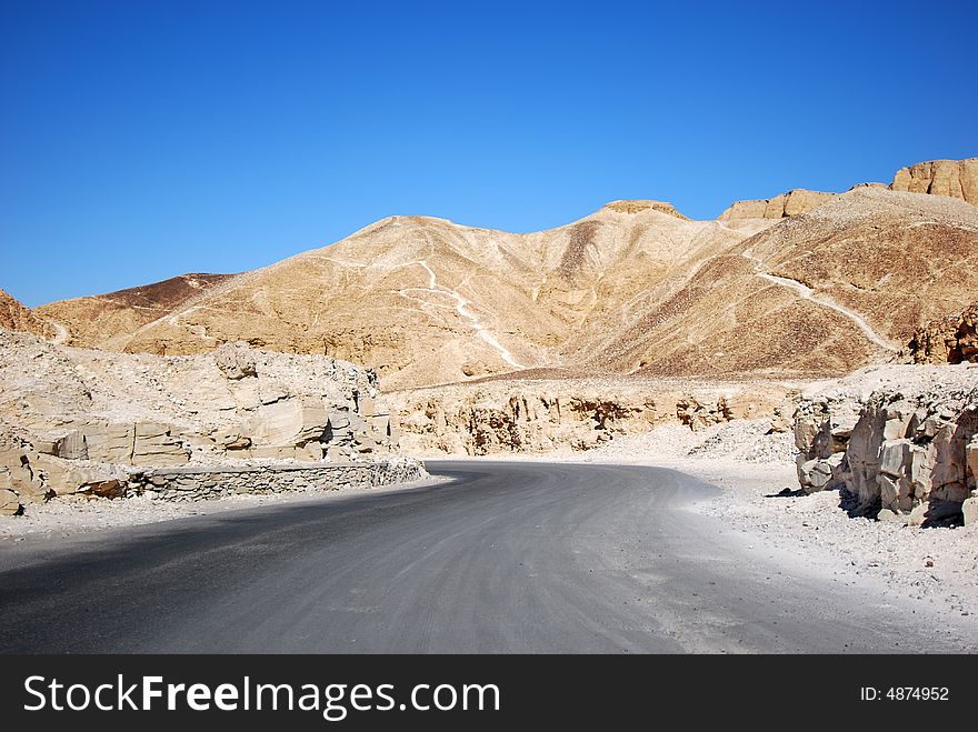 Road through the desert and sandy hills - valley of the kings in Luxor (ancient Thebes), Egypt. Road through the desert and sandy hills - valley of the kings in Luxor (ancient Thebes), Egypt