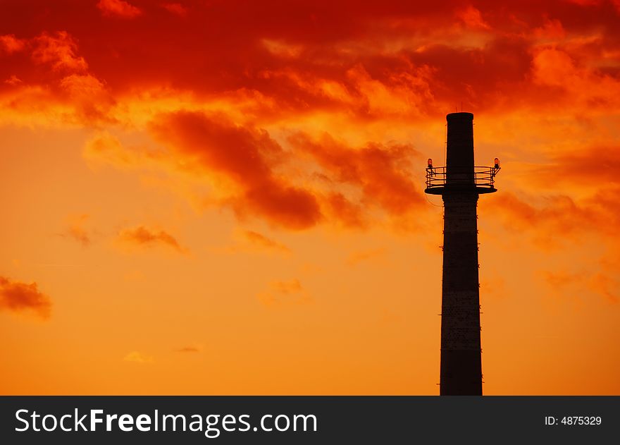 Old industrial chimney sihouette at beautiful warm sunset. Old industrial chimney sihouette at beautiful warm sunset