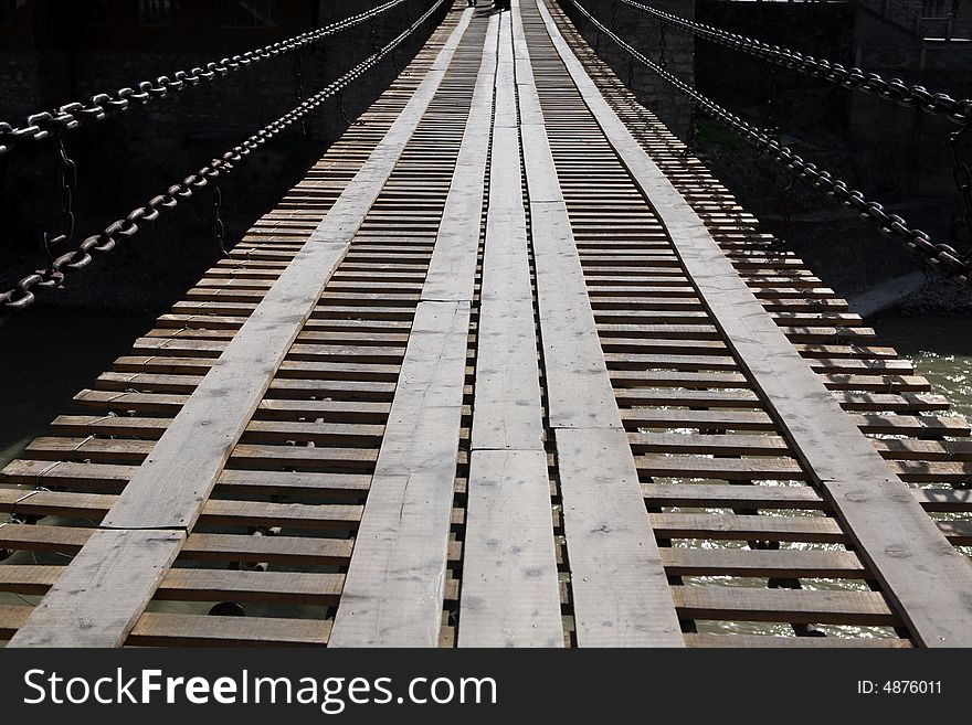 A old cable bridge over the river. A old cable bridge over the river.