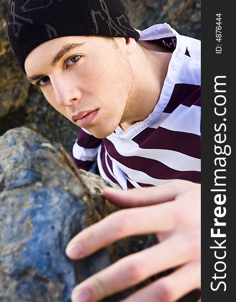 Young man portrait in casual clothing on the rocks. Young man portrait in casual clothing on the rocks