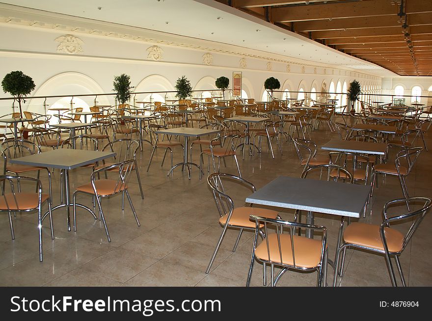 Empty cafe. Nobody in, metal chairs, metal tables.