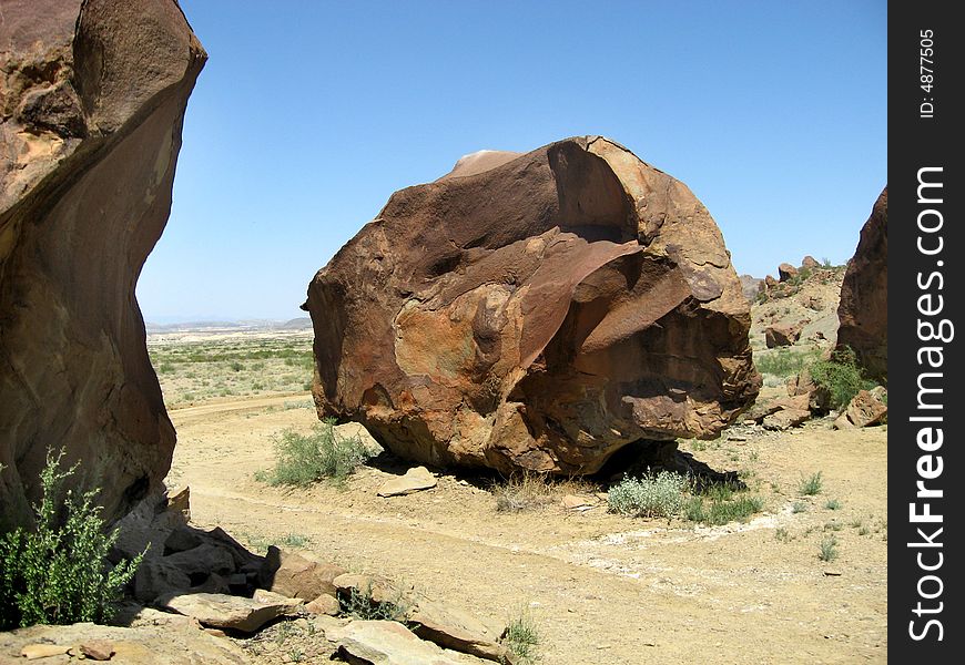 Boulder at the base of a mountain in Terlingua, Texas in the Chihuahuan desert near Big Bend National Park. Measures approximately 2 stories high. Boulder at the base of a mountain in Terlingua, Texas in the Chihuahuan desert near Big Bend National Park. Measures approximately 2 stories high.