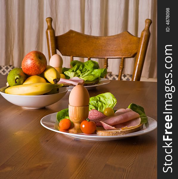 Table served with snacks. Fruits, vegetables, bread, egg, ham etc. Table served with snacks. Fruits, vegetables, bread, egg, ham etc.